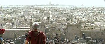 Movie still from “Agora” (2009), directed by Alejandro Amenábar – An old man in a red robe looking at a crowd of people; Extreme Wide shot, High angle