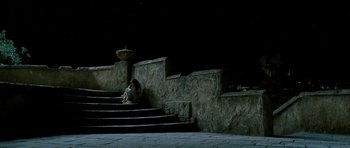 Movie still from “Agora” (2009), directed by Alejandro Amenábar – A woman sitting on the steps of an old building; Extreme Wide shot, High angle