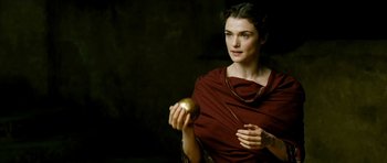 Movie still from “Agora” (2009), directed by Alejandro Amenábar – A woman holding an apple wearing a red robe; Close Up shot, High angle