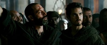 Movie still from “Agora” (2009), directed by Alejandro Amenábar – A group of men standing next to each other in a room; Close Up shot, Over the shoulder angle