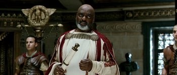 Movie still from “Agora” (2009), directed by Alejandro Amenábar – A man in a costume holding an object in his hand; Medium shot, Low angle