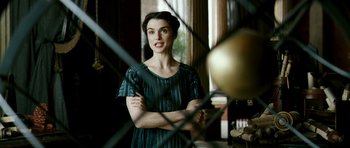 Movie still from “Agora” (2009), directed by Alejandro Amenábar – A woman standing in front of an iron gate; Medium shot, Over the shoulder angle