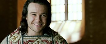 Movie still from “Agora” (2009), directed by Alejandro Amenábar – A person smiling for the camera; Close Up shot, Over the shoulder angle