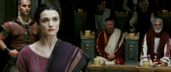 Movie still from “Agora” (2009), directed by Alejandro Amenábar – A woman standing in front of a man in ancient roman clothing; Close Up shot, Over the shoulder angle