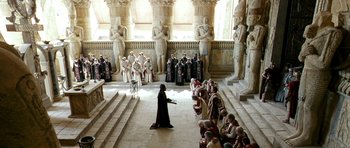 Movie still from “Agora” (2009), directed by Alejandro Amenábar – A woman in a long black dress stands in front of a group of people; Extreme Wide shot, High angle