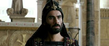 Movie still from “Agora” (2009), directed by Alejandro Amenábar – A man with a beard wearing a black hat; Close Up shot, Low angle