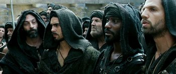 Movie still from “Agora” (2009), directed by Alejandro Amenábar – A group of men in black hoods standing next to each other; Medium shot, Over the shoulder angle