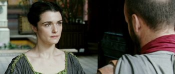 Movie still from “Agora” (2009), directed by Alejandro Amenábar – A woman in a black dress and a man in a gray shirt; Close Up shot, Over the shoulder angle