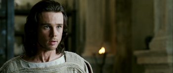 Movie still from “Agora” (2009), directed by Alejandro Amenábar – A man with long brown hair wearing a sweater; Close Up shot, Over the shoulder angle