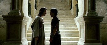 Movie still from “Agora” (2009), directed by Alejandro Amenábar – A man and a woman standing next to each other on steps; Medium shot, Over the shoulder angle