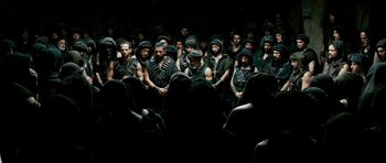 Movie still from “Agora” (2009), directed by Alejandro Amenábar – A group of men in black shirts and black hats; Wide shot, High angle