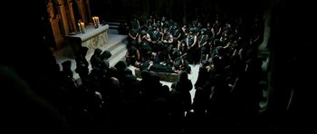 Movie still from “Agora” (2009), directed by Alejandro Amenábar – A group of people sitting on the ground in front of a candle; Wide shot, High angle