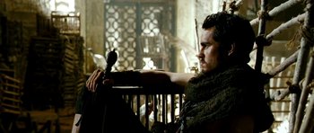 Movie still from “Agora” (2009), directed by Alejandro Amenábar – A man sitting in a chair holding a microphone; Medium shot, Over the shoulder angle