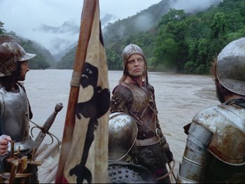 Movie still from “Aguirre, the Wrath of God” (1972), directed by Werner Herzog – A man wearing a helmet and armor on a boat; Medium shot, Low angle