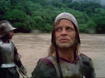 Movie still from “Aguirre, the Wrath of God” (1972), directed by Werner Herzog – A man wearing a viking helmet looking into the distance; Close Up shot, Low angle