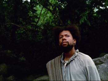 Movie still from “Aguirre, the Wrath of God” (1972), directed by Werner Herzog – A man standing in front of a tree with his eyes closed; Close Up shot, Low angle