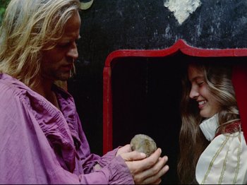 Movie still from “Aguirre, the Wrath of God” (1972), directed by Werner Herzog – A man and a woman are holding a rock; Close Up shot, Over the shoulder angle