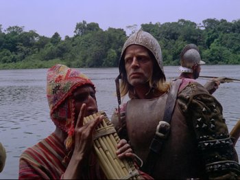 Movie still from “Aguirre, the Wrath of God” (1972), directed by Werner Herzog – Two men dressed in medieval costumes on a river; Medium shot, Low angle