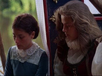 Movie still from “Aguirre, the Wrath of God” (1972), directed by Werner Herzog – Two young women dressed in period clothing; Medium shot, Over the shoulder angle