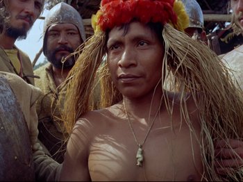 Movie still from “Aguirre, the Wrath of God” (1972), directed by Werner Herzog – A man in a crown and a necklace; Medium shot, Low angle