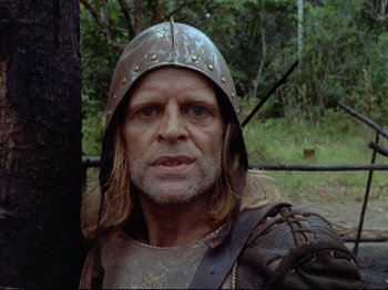Movie still from “Aguirre, the Wrath of God” (1972), directed by Werner Herzog – A person wearing a helmet; Close Up shot, Low angle