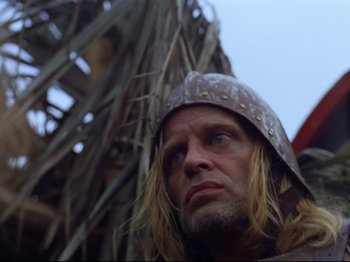 Movie still from “Aguirre, the Wrath of God” (1972), directed by Werner Herzog – A person wearing a helmet; Close Up shot, Low angle
