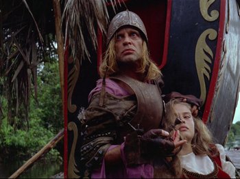 Movie still from “Aguirre, the Wrath of God” (1972), directed by Werner Herzog – A man and a woman dressed in medieval garb; Medium shot, Low angle