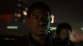 Movie still from “Snowfall” (2017), directed by Hiro Murai – A person with a cell phone; Close Up shot, Low angle