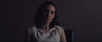 Movie still from “Ain't Them Bodies Saints” (2013), directed by David Lowery – A woman in a white shirt is sitting in a chair; Close Up shot, Low angle