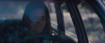 Movie still from “Ain't Them Bodies Saints” (2013), directed by David Lowery – A woman sitting in the driver's seat of a car; Close Up shot, Over the shoulder angle