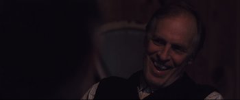 Movie still from “Ain't Them Bodies Saints” (2013), directed by David Lowery – A man with a goatee smiling for the camera; Close Up shot, Over the shoulder angle