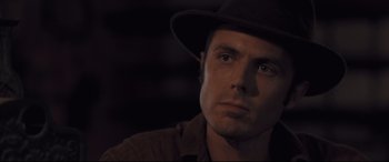 Movie still from “Ain't Them Bodies Saints” (2013), directed by David Lowery – A person wearing a hat and looking sad; Close Up shot, Low angle