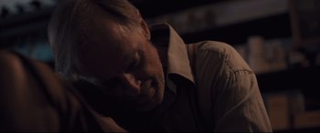 Movie still from “Ain't Them Bodies Saints” (2013), directed by David Lowery – A person with his head down; Close Up shot, Over the shoulder angle
