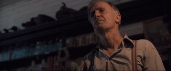 Movie still from “Ain't Them Bodies Saints” (2013), directed by David Lowery – A person standing in a room; Close Up shot, Low angle