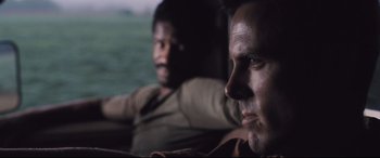 Movie still from “Ain't Them Bodies Saints” (2013), directed by David Lowery – Two men sitting next to each other in a car; Close Up shot, Over the shoulder angle