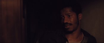 Movie still from “Ain't Them Bodies Saints” (2013), directed by David Lowery – A person in a dark room; Close Up shot, Over the shoulder angle