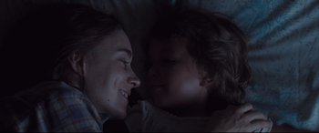 Movie still from “Ain't Them Bodies Saints” (2013), directed by David Lowery – A woman and a child laying in a bed; Close Up shot, Over the shoulder angle