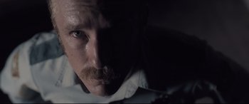 Movie still from “Ain't Them Bodies Saints” (2013), directed by David Lowery – A person with a mustache; Extreme Close Up shot, Low angle