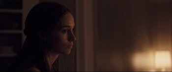 Movie still from “Ain't Them Bodies Saints” (2013), directed by David Lowery – A woman looking out of a window at night; Close Up shot, Over the shoulder angle