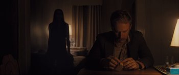 Movie still from “Ain't Them Bodies Saints” (2013), directed by David Lowery – A man sitting at a table in front of a woman; Medium shot, Over the shoulder angle