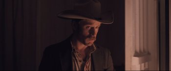 Movie still from “Ain't Them Bodies Saints” (2013), directed by David Lowery – A man wearing a cowboy hat in the dark; Close Up shot, Low angle