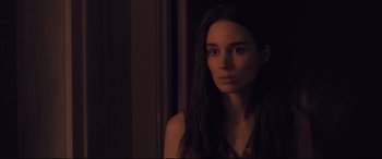 Movie still from “Ain't Them Bodies Saints” (2013), directed by David Lowery – A woman with long black hair stares into the camera; Close Up shot, Over the shoulder angle