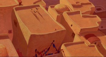 Movie still from “Aladdin” (1992), directed by John Musker – An aerial view of a desert area with sand dunes; Extreme Wide shot, Overhead angle