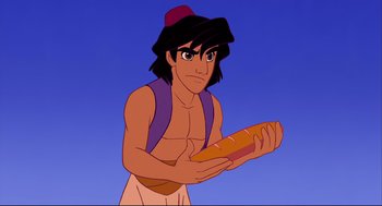 Movie still from “Aladdin” (1992), directed by John Musker – A man holding a loaf of bread in front of a blue sky; Medium shot, Over the shoulder angle