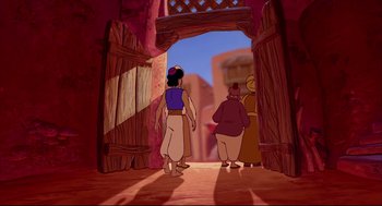 Movie still from “Aladdin” (1992), directed by John Musker – A couple of people that are standing in the dirt; Wide shot, High angle