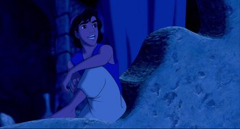 Movie still from “Aladdin” (1992), directed by John Musker – A woman sitting on top of a rock in the dark; Medium shot, Overhead angle