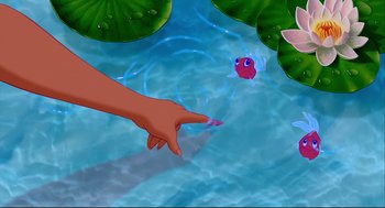 Movie still from “Aladdin” (1992), directed by John Musker – An image of a person pointing at a fish in the water; Medium shot, Overhead angle
