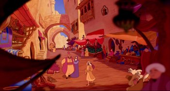 Movie still from “Aladdin” (1992), directed by John Musker – A street scene with a man and a woman in the middle of the street; Extreme Wide shot, High angle