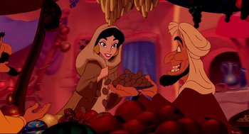 Movie still from “Aladdin” (1992), directed by John Musker – A woman and a bearded man in a market; Wide shot, Overhead angle