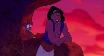 Movie still from “Aladdin” (1992), directed by John Musker – A man laughing while sitting next to an apple; Medium shot, Over the shoulder angle
